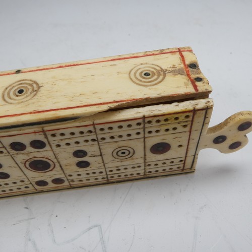 177 - An early 19th century French Prisoner of War carved bone Games Box, the sliding cover pierced for cr... 