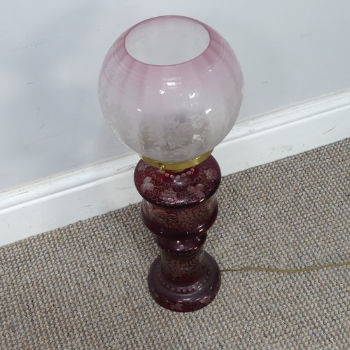 565 - An antique ruby glass electrified Oil Lamp, with etched glass shade, H 49 cm, together with two bras... 