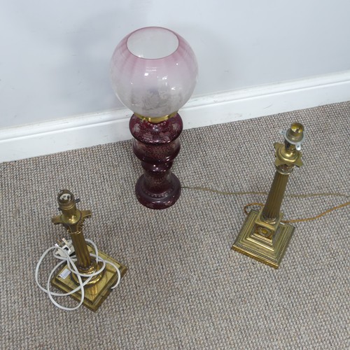 565 - An antique ruby glass electrified Oil Lamp, with etched glass shade, H 49 cm, together with two bras... 