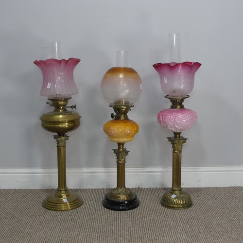 544 - A Victorian Youngs brass Oil lamp, cranberry and etched glass shade raised on brass reservoir and co... 