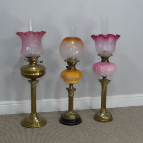 544 - A Victorian Youngs brass Oil lamp, cranberry and etched glass shade raised on brass reservoir and co... 