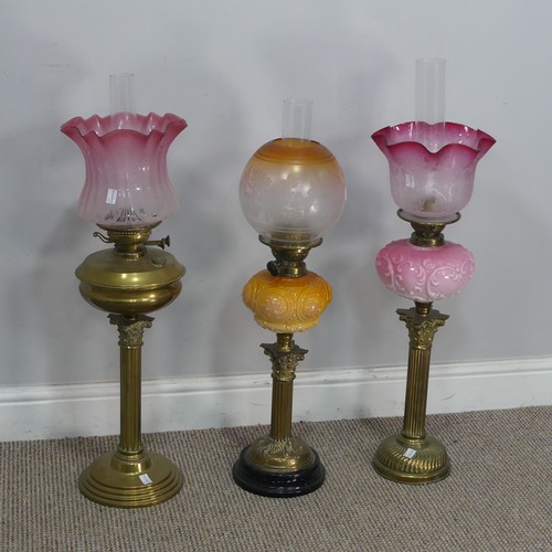 544 - A Victorian Youngs brass Oil lamp, cranberry and etched glass shade raised on brass reservoir and co... 