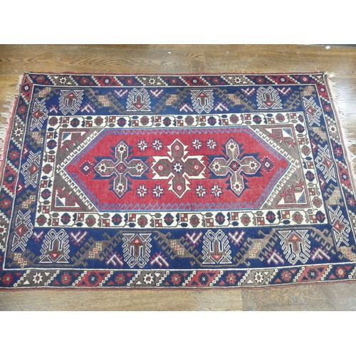 587 - Tribal Rugs; a Turkish Rug, blue and red ground with all over geometric pattern set within a wide bo... 