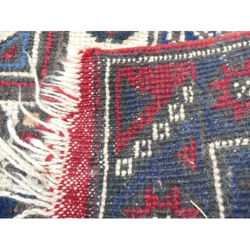 587 - Tribal Rugs; a Turkish Rug, blue and red ground with all over geometric pattern set within a wide bo... 