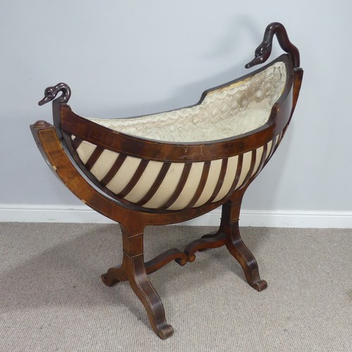 An unusual Regency mahogany swing Cradle / Crib, circa 1820, of navette form with slatted sides and inlaid with stringing, the frame surmounted by a swan's head, raised on downswept platform feet joined by scroll stretchers, note with damages and missing column to support swan, see images, W 134 cm x H 120 cm x D 54 cm.
