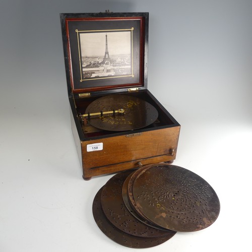 A late 19th century walnut cased Polyphon, with decorative hinged lid, the inside lid with photograph of the Eiffel Tower, Paris, playing 20.5cm diameter discs on one-piece comb, serial number 150128, 26cm wide overall, with ten discs.