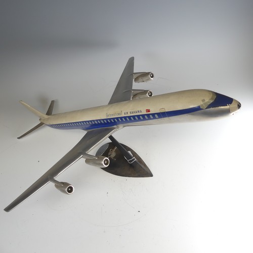 An aircraft manufacturers desktop metal model Aeroplane, 1:72 scale aeroplane of International Air Bahamas DC-8 model 61, Sunbird Superjet, on stand and with original Box, together with two other Air Bahamas plastic model Aeroplanes, one being a super DC-8 N8630, stamped 'Belplast Milano, made in Italy', with stand, the other being International Caribbean, stamped 'Skyland Models', with stand(3) Provenance: Major Norman Edward Ricketts, one of the founders of International Air Bahamas, and then by descent. 