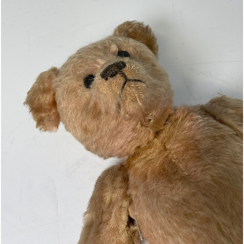 149 - A vintage Teddy Bear, with black button eyes, straw filling, sewn nose, light orange plush and felt ... 