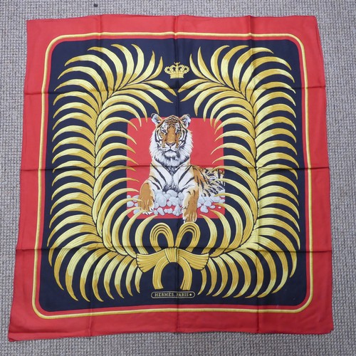 324 - A Hermès silk twill scarf: Royal Tiger design, gold and black on red ground, hand rolled edges, two ... 