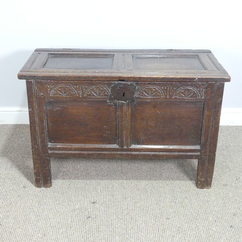 497 - An 18th century small oak Coffer, panelled top with pin hinges, above carved panel edges, raised on ... 