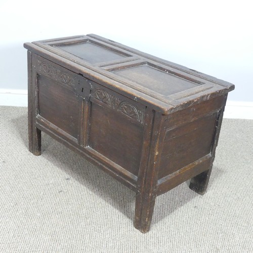 497 - An 18th century small oak Coffer, panelled top with pin hinges, above carved panel edges, raised on ... 