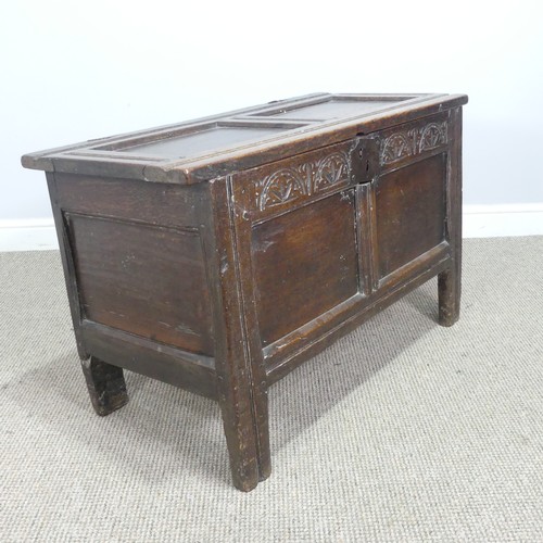 497 - An 18th century small oak Coffer, panelled top with pin hinges, above carved panel edges, raised on ... 