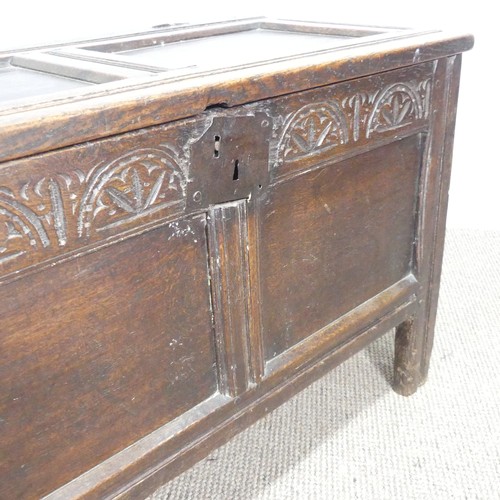 497 - An 18th century small oak Coffer, panelled top with pin hinges, above carved panel edges, raised on ... 