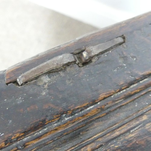 497 - An 18th century small oak Coffer, panelled top with pin hinges, above carved panel edges, raised on ... 