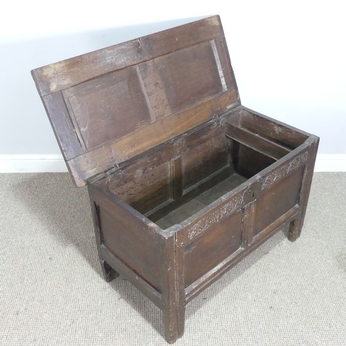 497 - An 18th century small oak Coffer, panelled top with pin hinges, above carved panel edges, raised on ... 