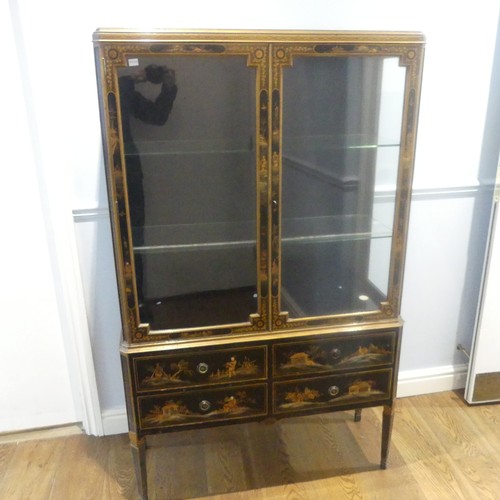 546 - An early 20th century Chinoiserie display Cabinet, black lacquered with gilt painted decorations, tw... 