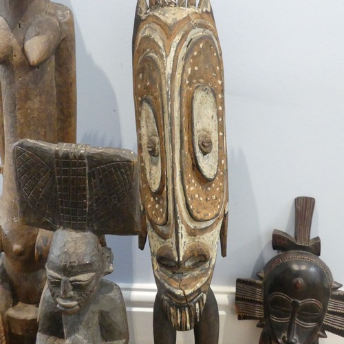 583 - Tribal Artefacts: A Papua New Guineau Sepik Mask, together with a figure similar, and three African ... 