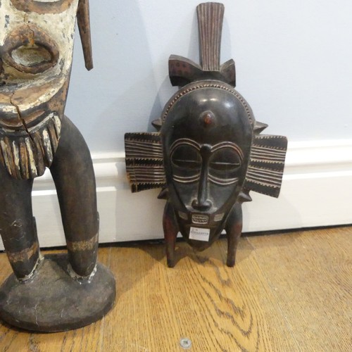 583 - Tribal Artefacts: A Papua New Guineau Sepik Mask, together with a figure similar, and three African ... 