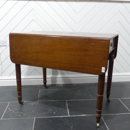 483 - A 19th century mahogany Pembroke Table, with ebony stringing raised on turned supports and brass cas... 