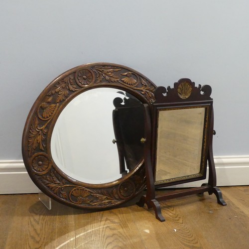 567 - An early 20th century oval Wall Mirror, with carved oak frame, W 57 cm x H 50 cm, together with a sm... 