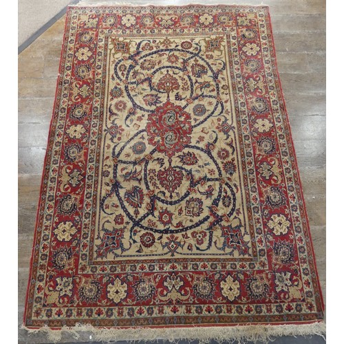 588 - Tribal Rugs; a finely hand-knotted old Isfahan silk rug, of classic design, the cream ground woven w... 