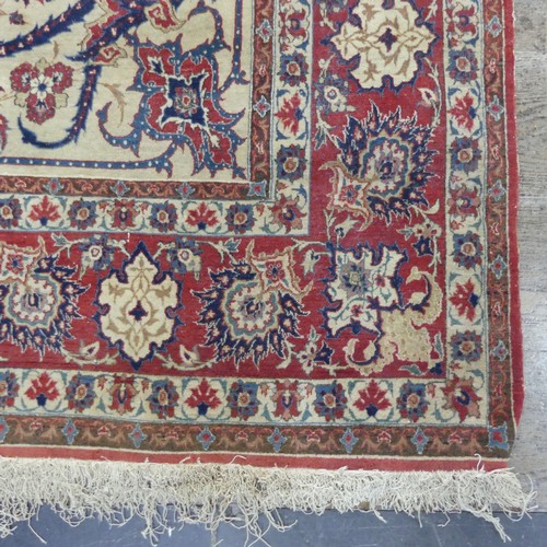 588 - Tribal Rugs; a finely hand-knotted old Isfahan silk rug, of classic design, the cream ground woven w... 