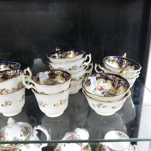 369 - A 19th century Staffordshire part tea set, comprising teapot, sugar basin and cream jug with sixteen... 