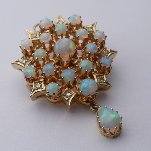 220 - An antique style opal and diamond Pendant / Brooch, the starburst cluster set seventeen circular cab... 