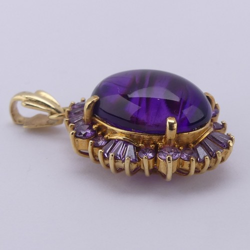 221 - A cabochon amethyst Pendant, the oval central amethyst approx. 17.5mm long, above a surround of pale... 