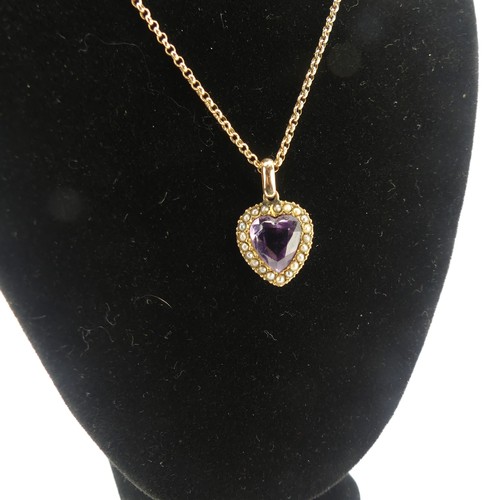 228 - A late Victorian amethyst and seed pearl Pendant, the heart shaped facetted amethyst within a surrou... 