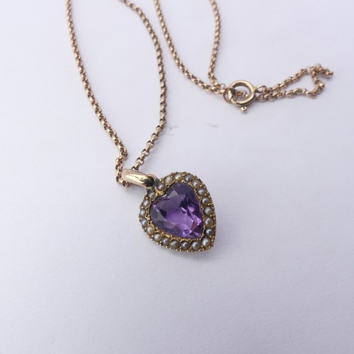 228 - A late Victorian amethyst and seed pearl Pendant, the heart shaped facetted amethyst within a surrou... 