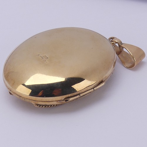 229 - A 9ct yellow gold oval double hinged Locket, in the Victorian style, the front with foliate decorati... 