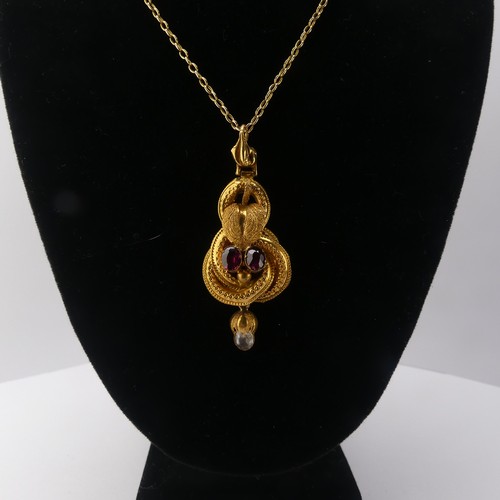 231 - A 19thC gold Pendant, set with two oval facetted garnets and a rock crsytal drop below, unmarked, te... 