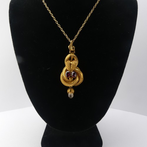 231 - A 19thC gold Pendant, set with two oval facetted garnets and a rock crsytal drop below, unmarked, te... 