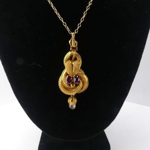 231 - A 19thC gold Pendant, set with two oval facetted garnets and a rock crsytal drop below, unmarked, te... 