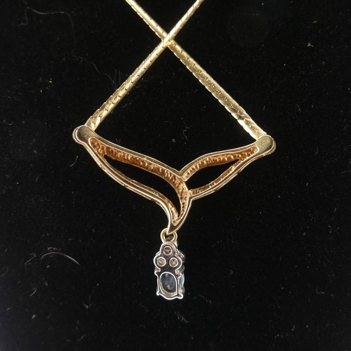 232 - A 9ct gold sapphire and diamond Pendant, the oval facetted sapphire 6.3mm long with three diamond se... 