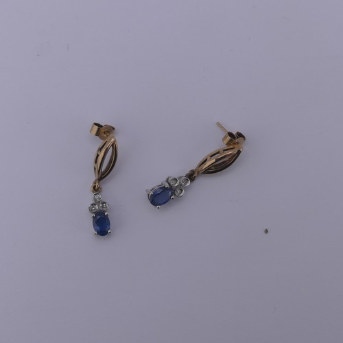 232 - A 9ct gold sapphire and diamond Pendant, the oval facetted sapphire 6.3mm long with three diamond se... 