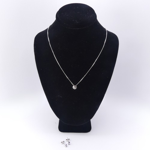 233 - A contemporary 18ct white gold and diamond Pendant and Earring Suite, the brilliant cut stone approx... 