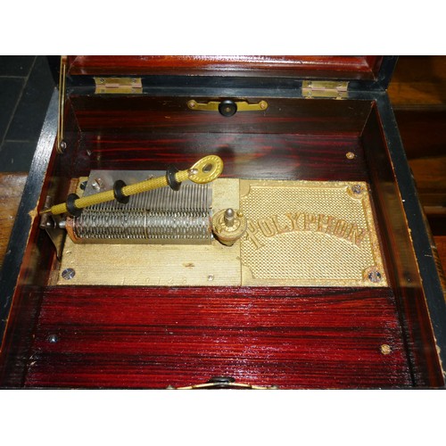 158 - A late 19th century walnut cased Polyphon, with decorative hinged lid, the inside lid with photograp... 