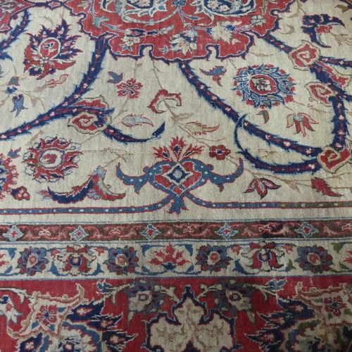 588 - Tribal Rugs; a finely hand-knotted old Isfahan silk rug, of classic design, the cream ground woven w... 