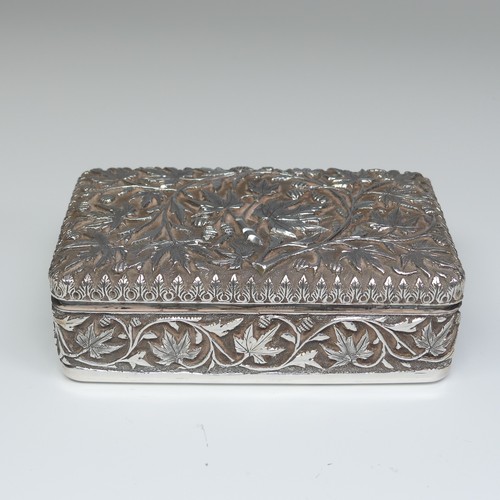 40 - An Indian silver Cigarette Box, of hinged rectangular form with all over foliate decoration, cedar l... 