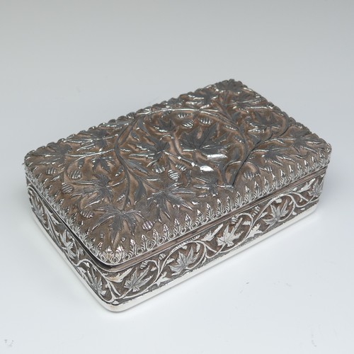 40 - An Indian silver Cigarette Box, of hinged rectangular form with all over foliate decoration, cedar l... 