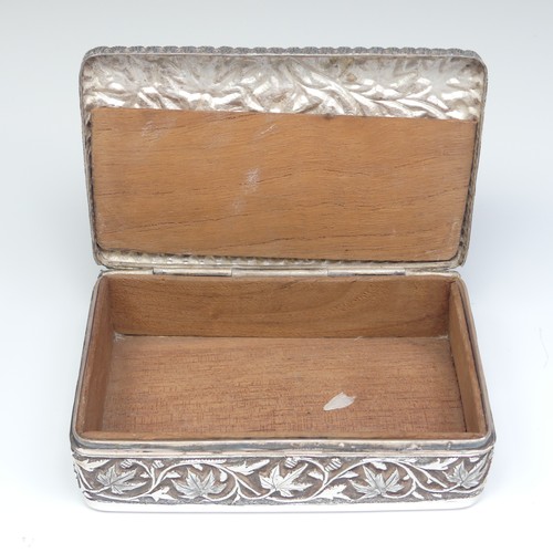 40 - An Indian silver Cigarette Box, of hinged rectangular form with all over foliate decoration, cedar l... 