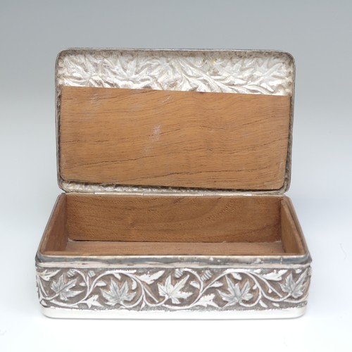 40 - An Indian silver Cigarette Box, of hinged rectangular form with all over foliate decoration, cedar l... 