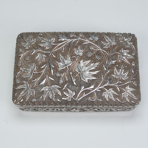 40 - An Indian silver Cigarette Box, of hinged rectangular form with all over foliate decoration, cedar l... 