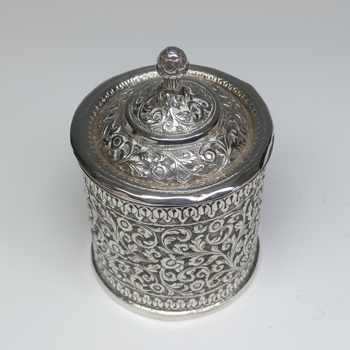 41 - An Indian circular silver Pot and Cover, with all over scrolling foliate decoration, the removable c... 