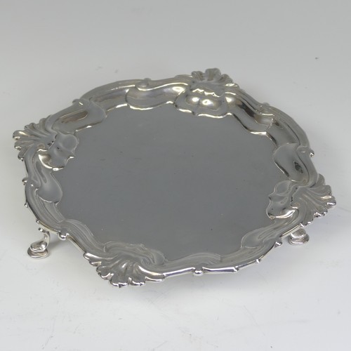 28 - A George II silver Waiter, by Hugh Mills, hallmarked London 1747, of shaped square form with shell c... 