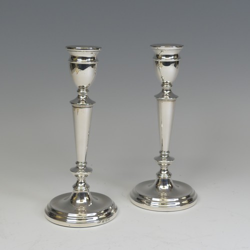 29 - A pair of Elizabeth II silver Candlesticks, by A T Cannon Ltd., hallmarked Birmingham, 1973, with we... 