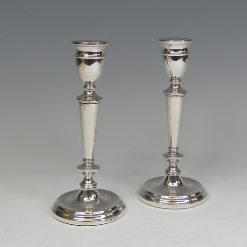 29 - A pair of Elizabeth II silver Candlesticks, by A T Cannon Ltd., hallmarked Birmingham, 1973, with we... 