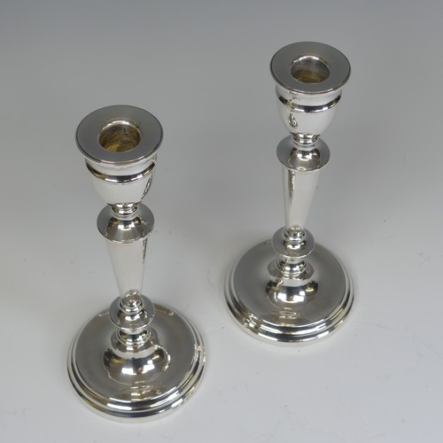 29 - A pair of Elizabeth II silver Candlesticks, by A T Cannon Ltd., hallmarked Birmingham, 1973, with we... 